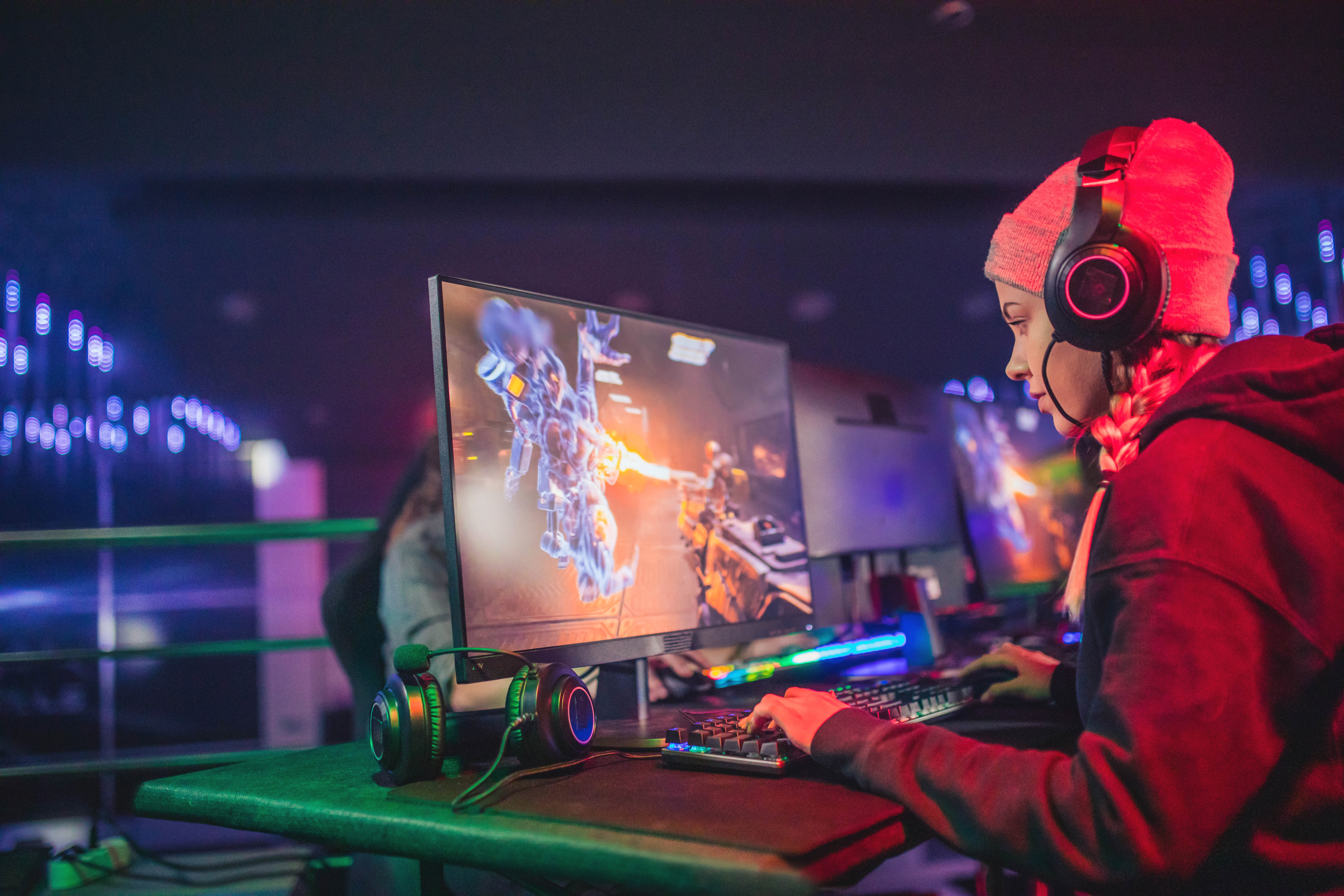 A gamer, mid-play, in front of screen.